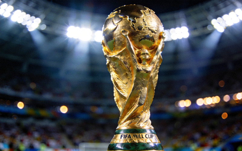 The FIFA World Cup trophy shining under stadium lights